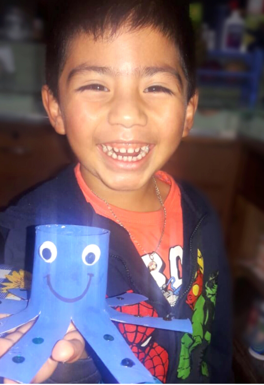 GoodNews4 Maya Childcare student sharing his completed school work at home via photo