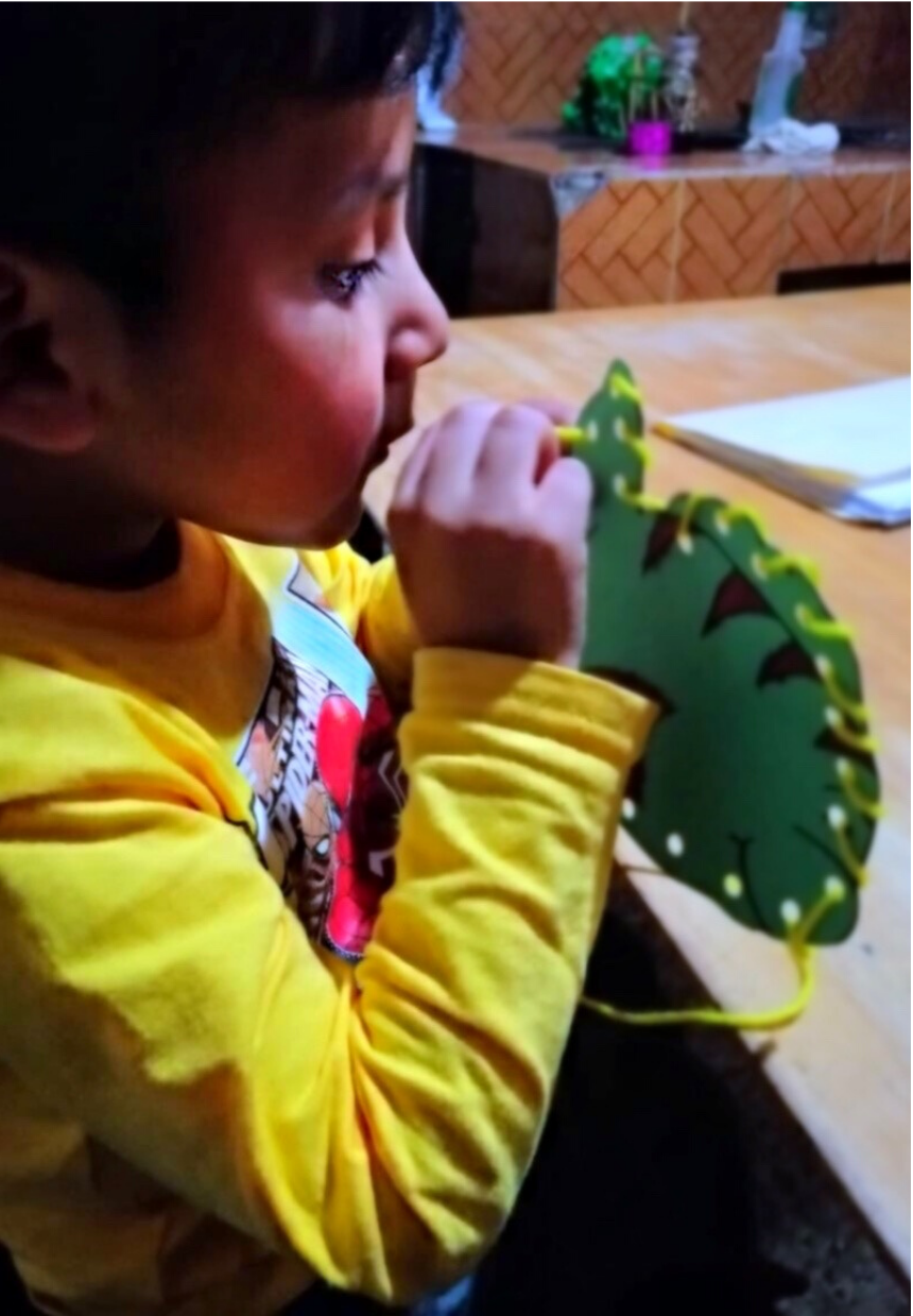 GoodNews3 Maya Childcare student practicing fine motor sewing task at home
